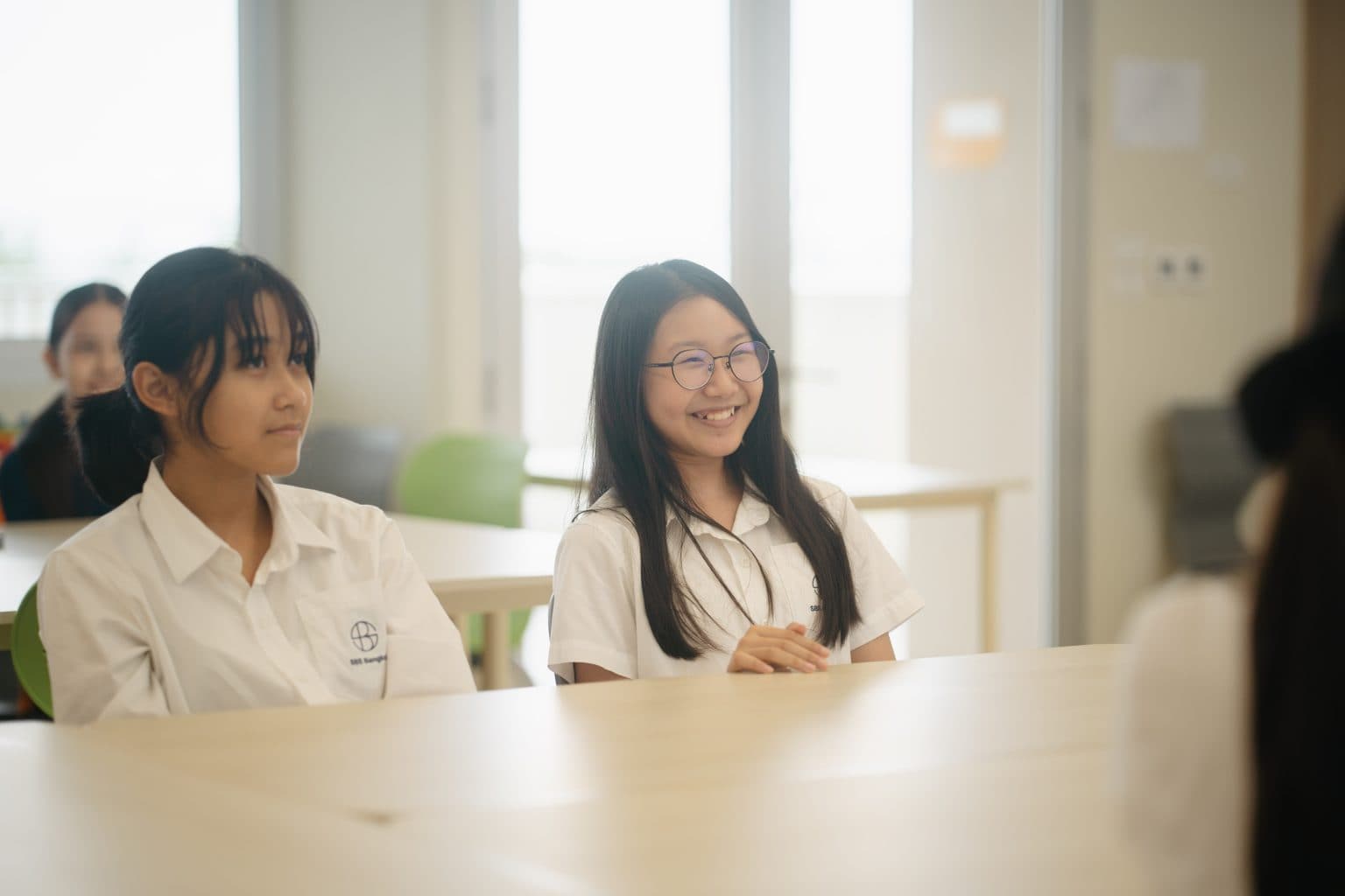 Two students smiling in class