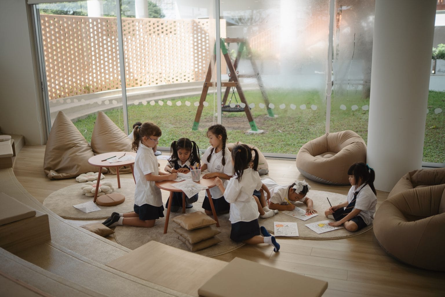 Pupils reading and relaxing together on floor cushions