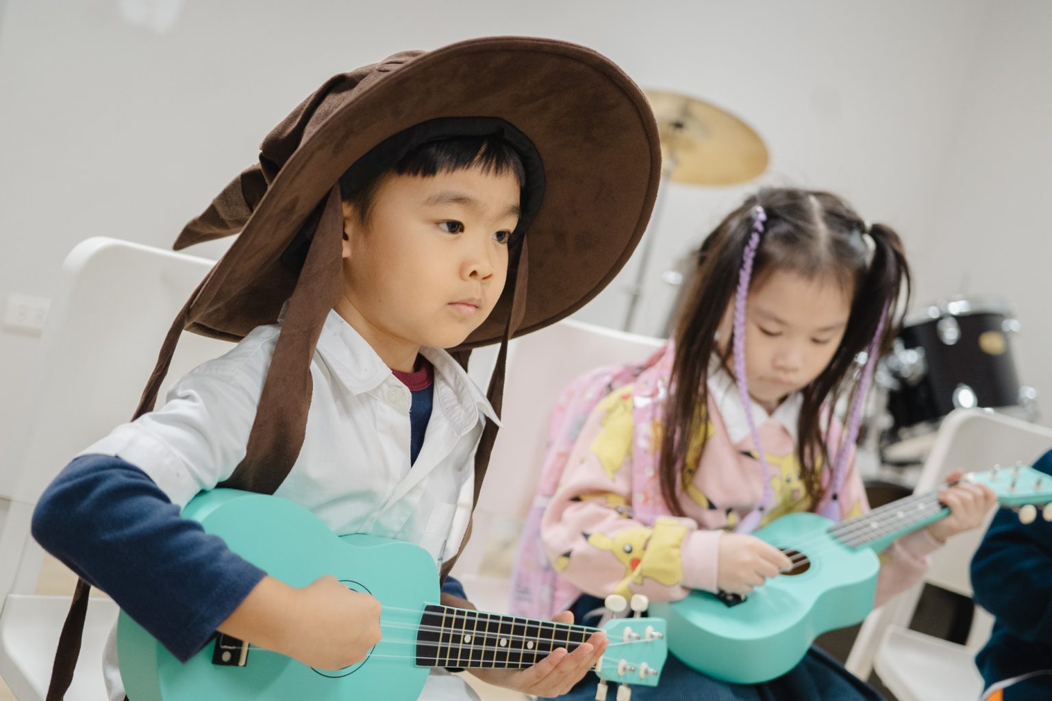 Pupils playing ukuleles in a music lesson