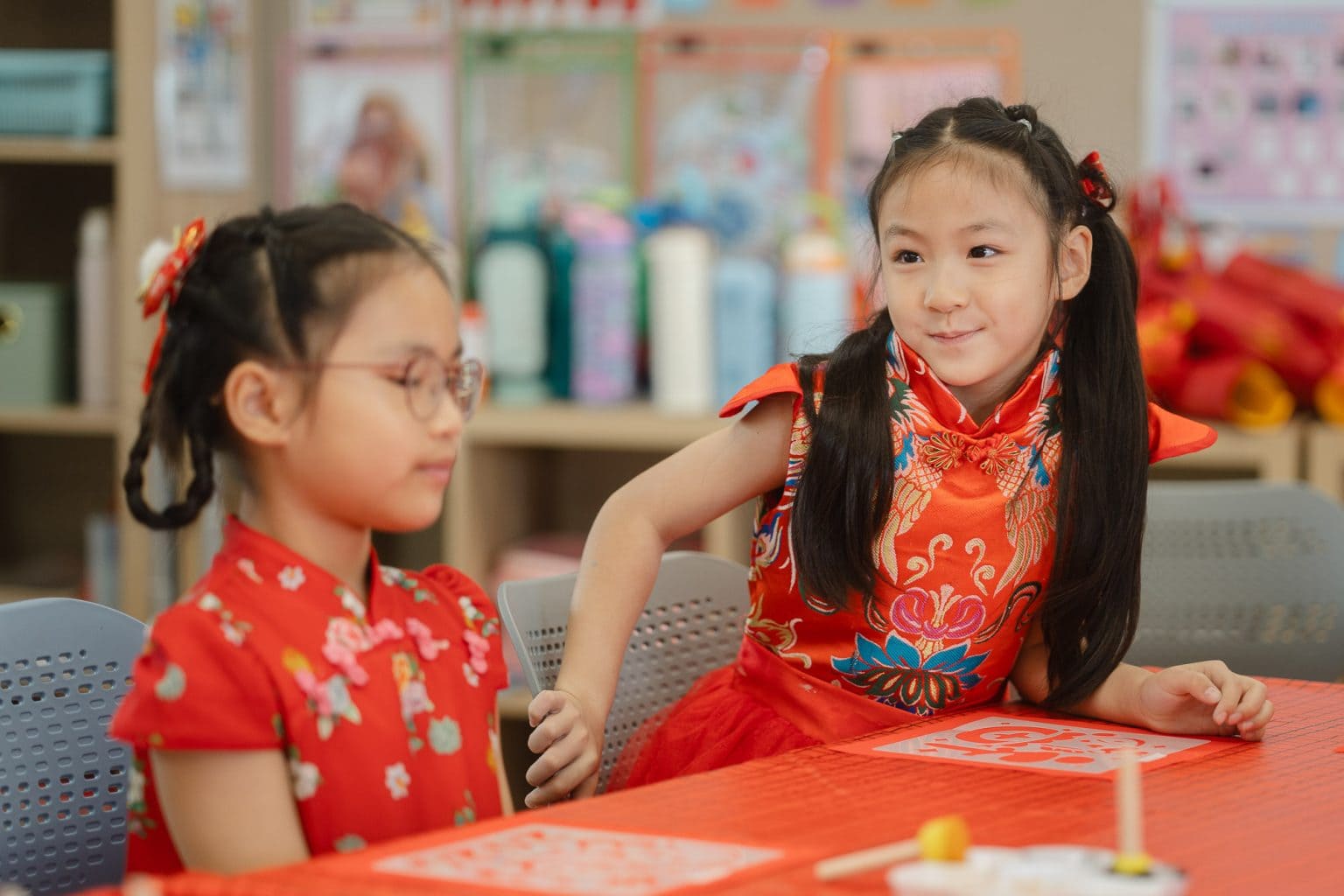 Two pupils in traditional Chinese dress at Lunar New Year