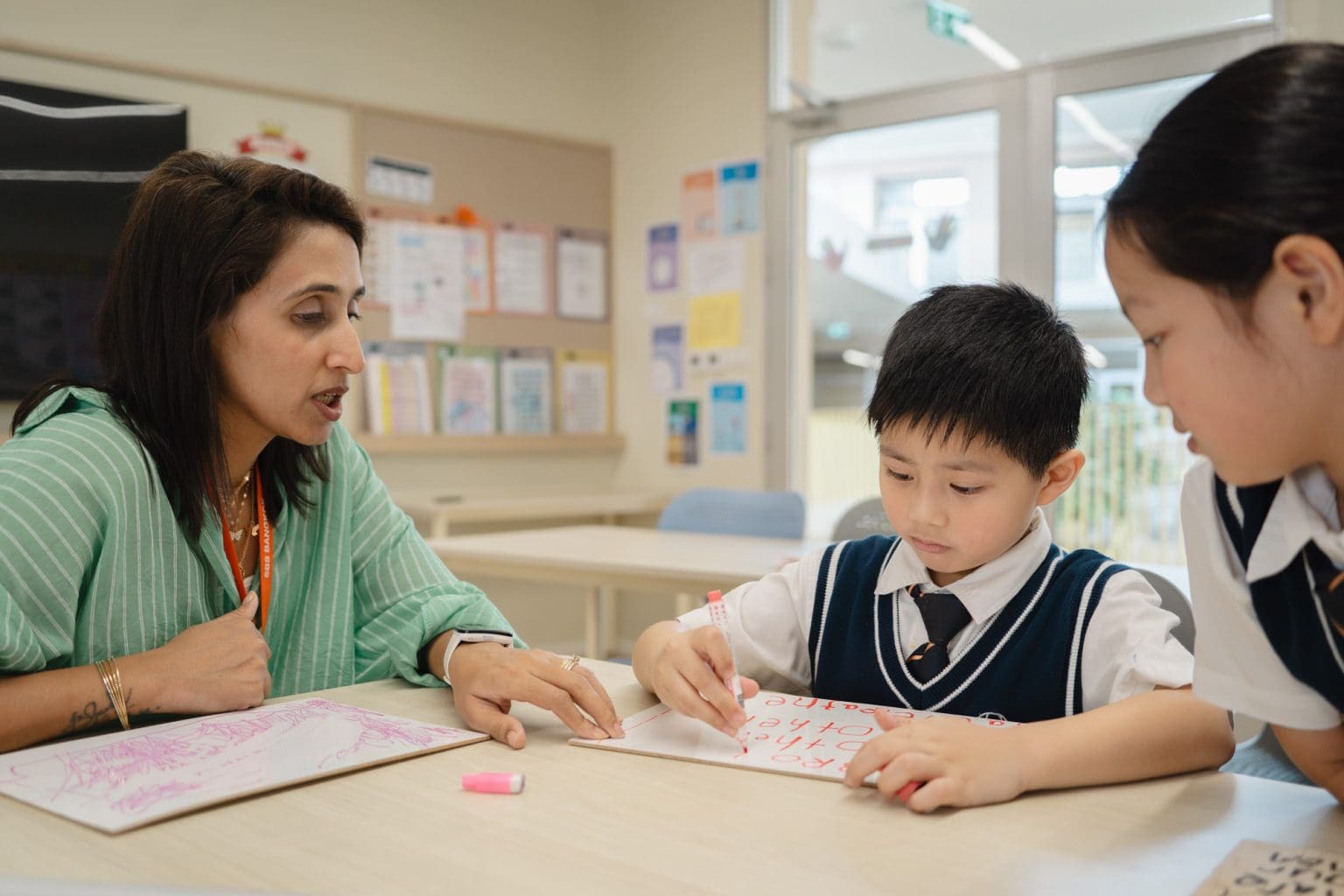 A teacher giving feedback to a pupil on his writing