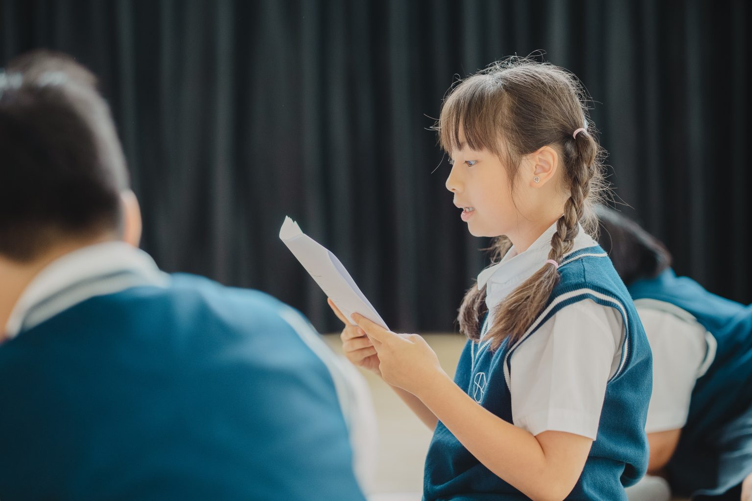 A pupil reading her lines in a drama lesson