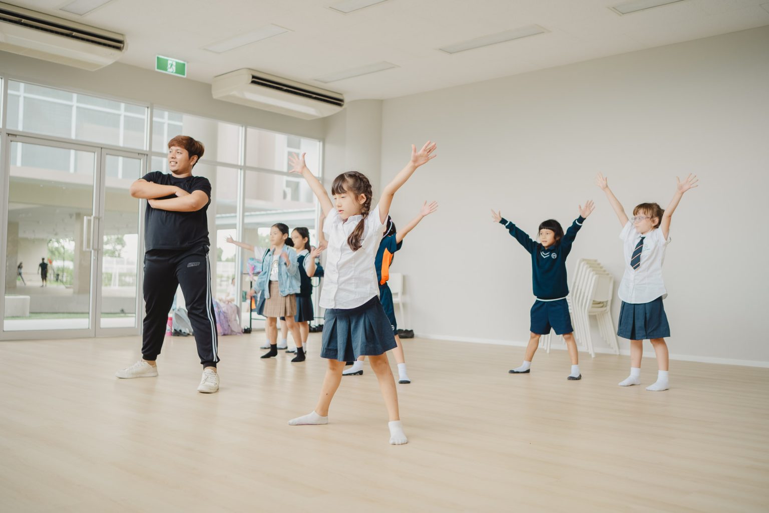 Pupils moving and stretching in the drama studio