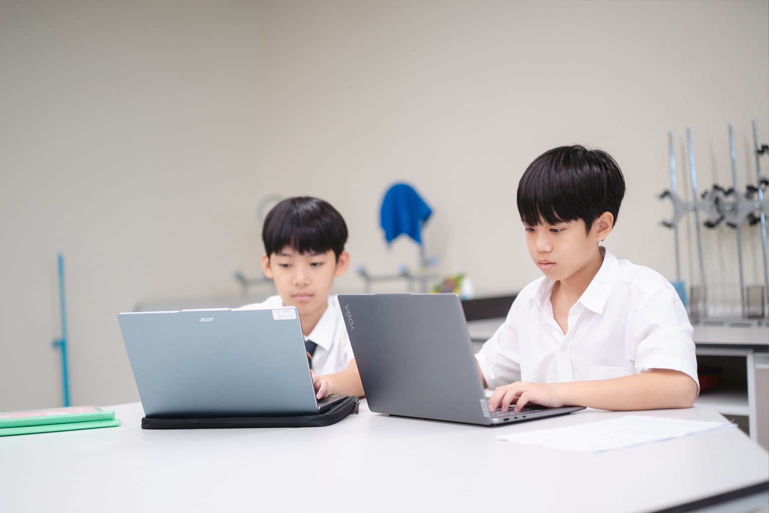 Two students working on laptops