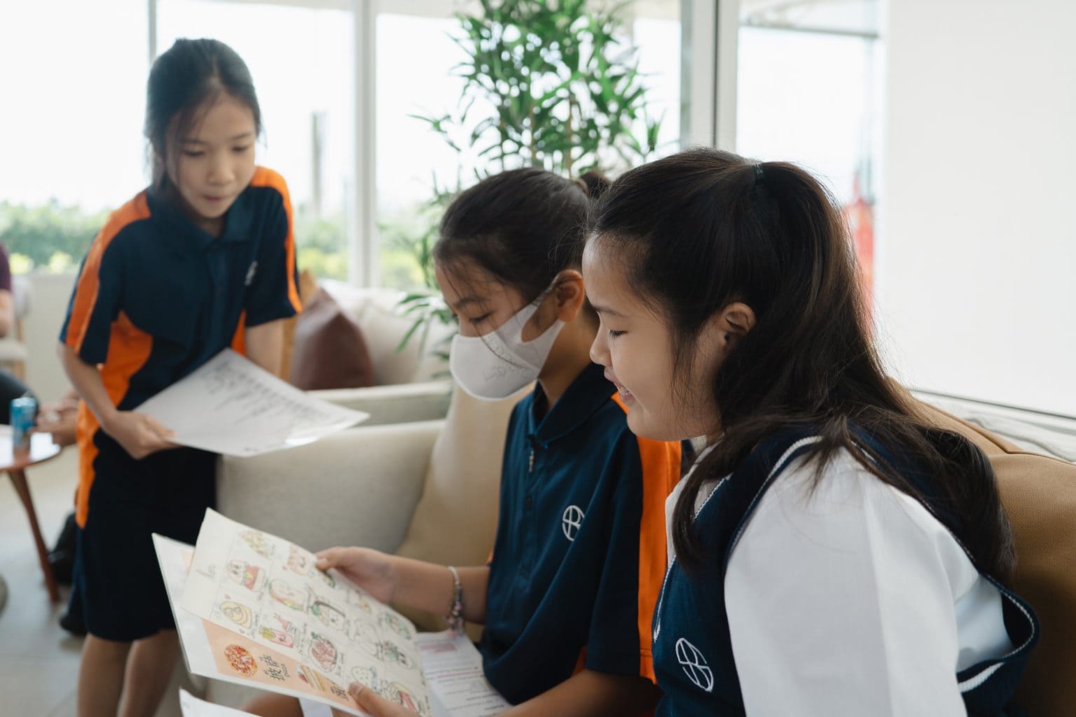 Three pupils working together on a reading task