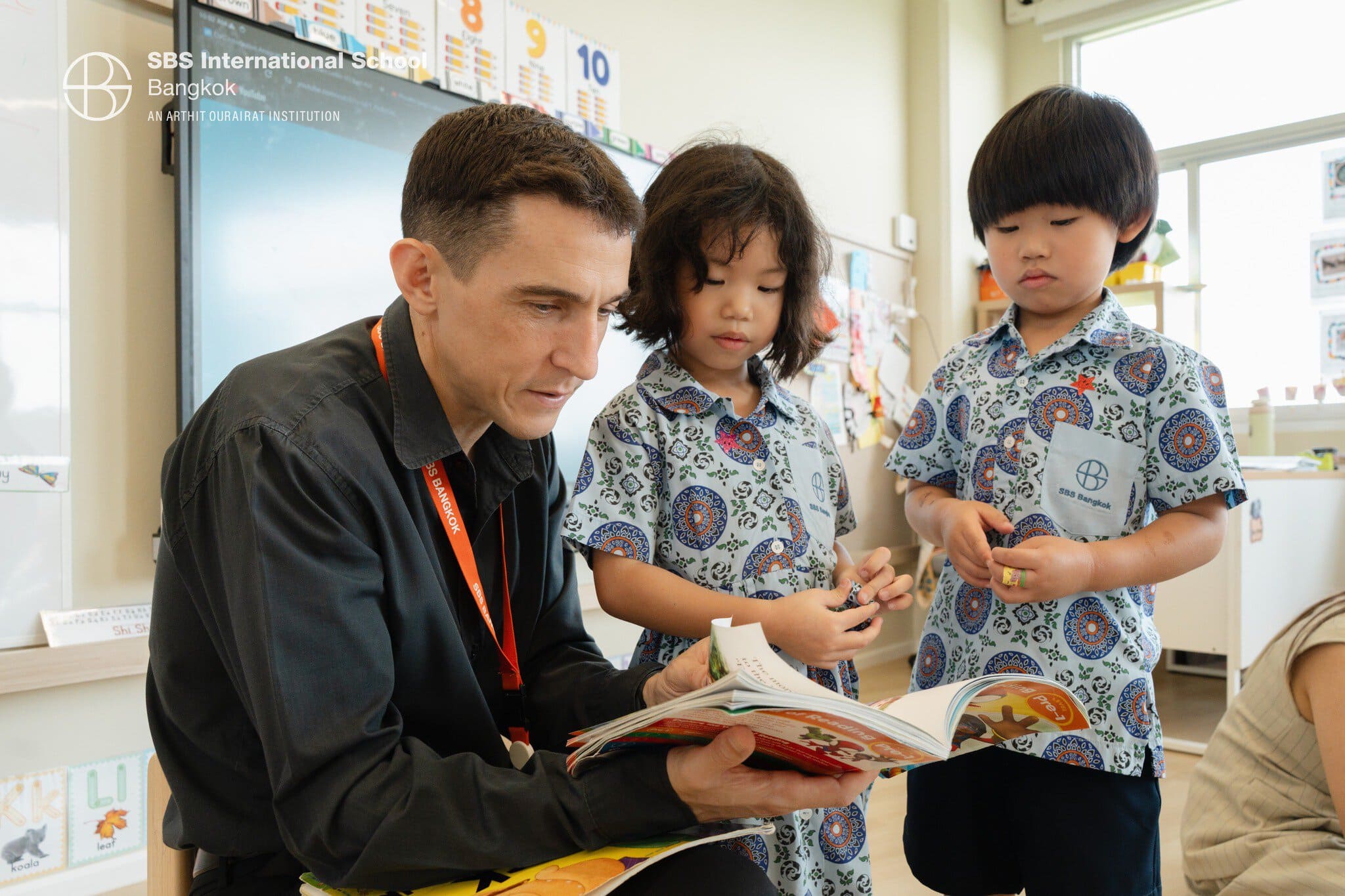 Reading with young students during Book Week at SBS International School Bangkok.