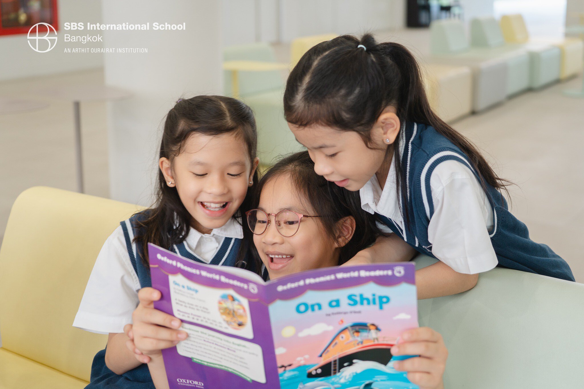 Children enjoying reading a book during D.E.A.R. Time at SBS International School Bangkok.