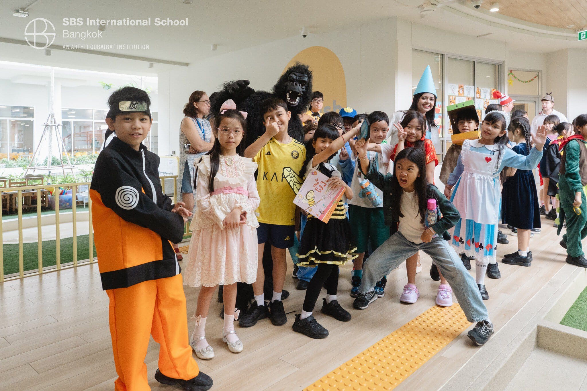 Children in colourful costumes celebrating reading and storytelling at SBS International School Bang.