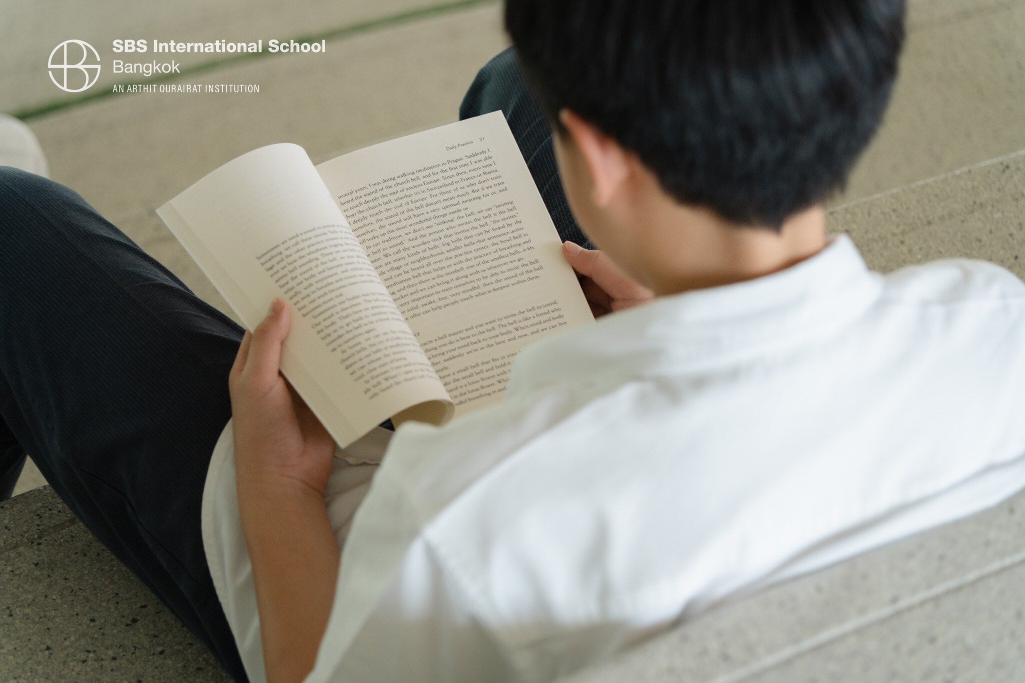 Young student enjoying reading a book during D.E.A.R. Time at SBS International School Bangkok.