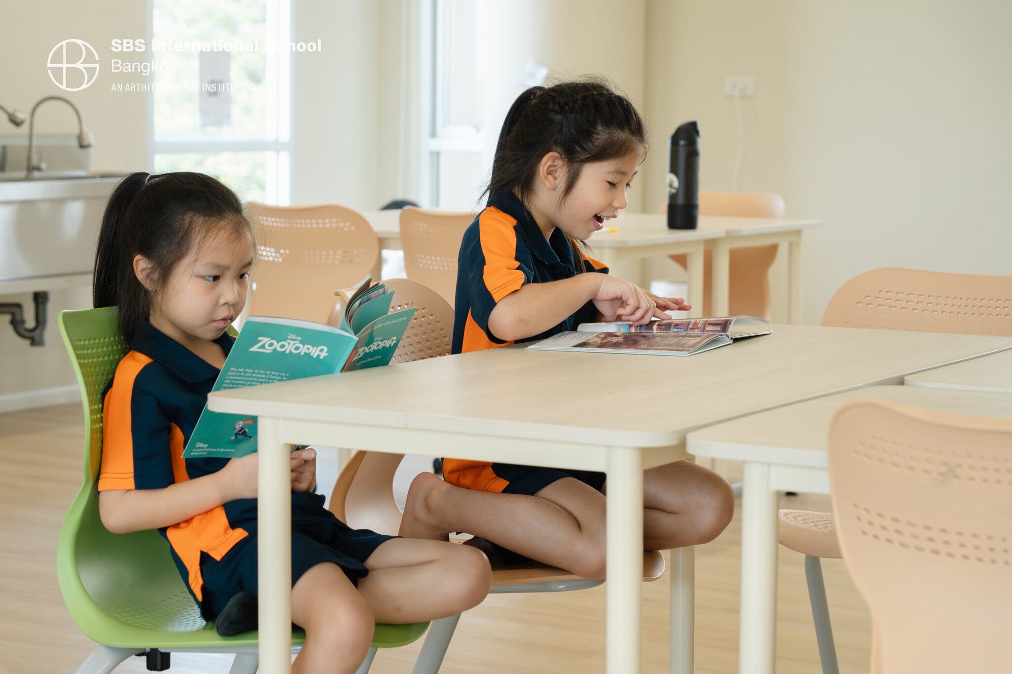 Two students enjoying reading books during D.E.A.R. Time at SBS Bangkok.