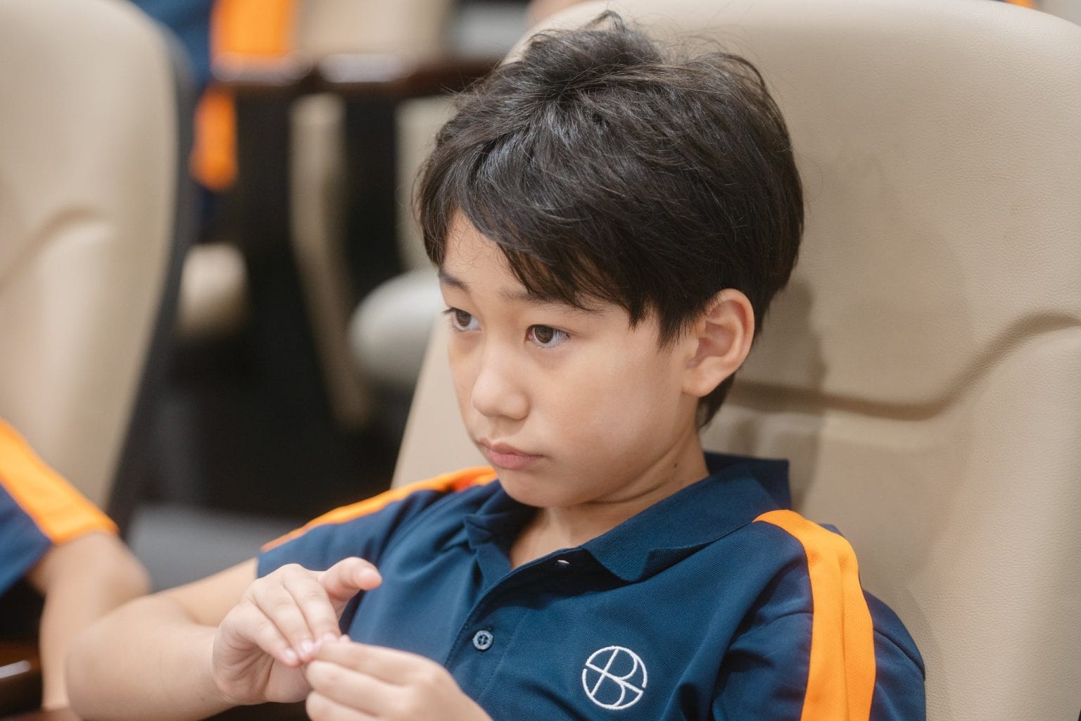 A Year 3 pupil listening closely in an assembly