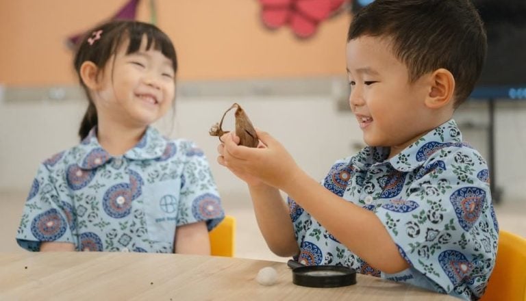 An Early Years child exploring a butterfly cocoon